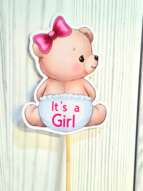 Teddy bear with a pink bow and 'It's a Girl' sign on a white background