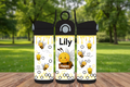 Three insulated water bottles with bee design and 'Lily' and 'Happy' text on a wooden surface.